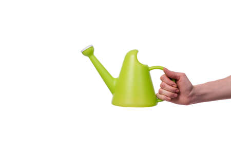 Hand holding watering can isolated on whiteの写真素材