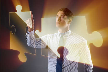 Businessman in business concept with puzzle pieceの写真素材
