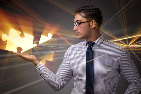Businessman in business concept with puzzle pieceの写真素材