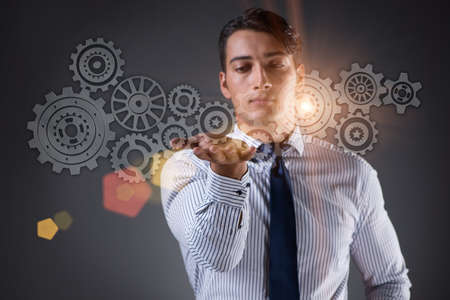 Businessman with cogwheels gear in teamwork concept
