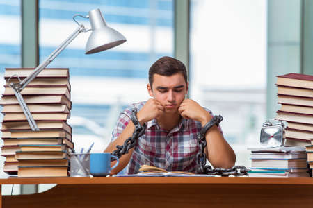 Young man preparing for graduation exams in collegeの写真素材