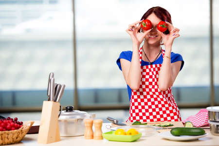 Woman preparing salad in the kitchenの写真素材