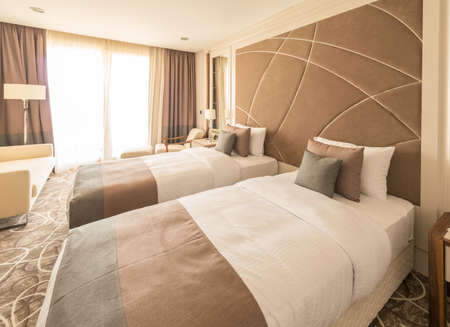 Modern hotel room with big bedの写真素材