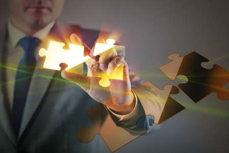 Businessman in business concept with puzzle pieceの写真素材