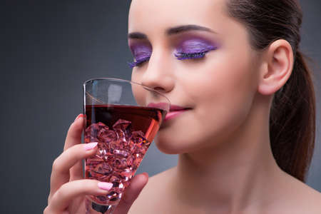 Nice woman drinking red cocktailの写真素材