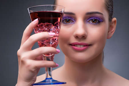 Nice woman drinking red cocktail