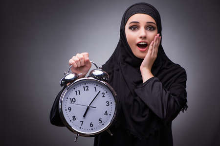 Muslim woman in black dress against dark backgroundの写真素材