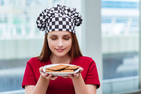 Young cook preparing cookies in the kitchenの写真素材