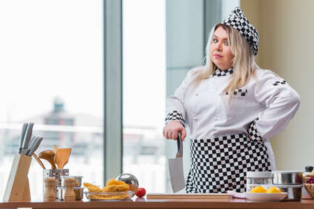 Young chef cook working in the kitchenの写真素材