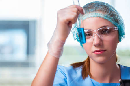 Young student working with chemical solutions in labの写真素材