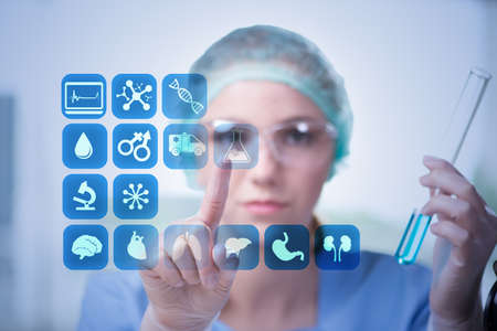 Woman doctor pressing buttons with various medical icons