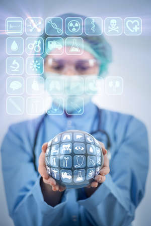 Doctor holding earth in global medicine conceptの写真素材