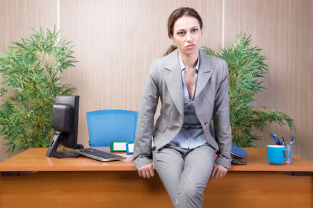 Woman under stress working in the officeの写真素材