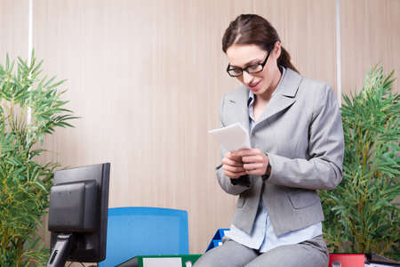 Office woman making paper airplanesの写真素材