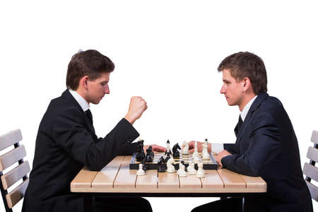 Twin brothers playing chess isolated on white