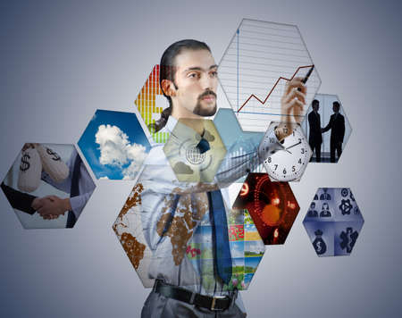 Businessman pressing virtual buttons in business conceptの写真素材