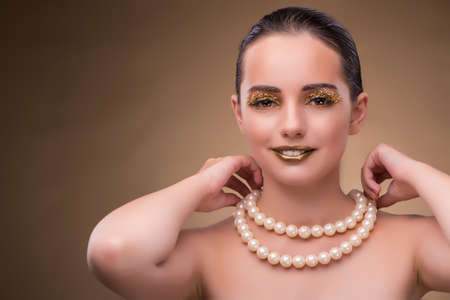 Woman with pearl necklace isolated on whiteの写真素材