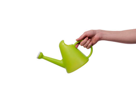 Hand holding watering can isolated on white