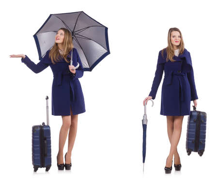 Woman with suitcase and umbrella isolated on whiteの写真素材