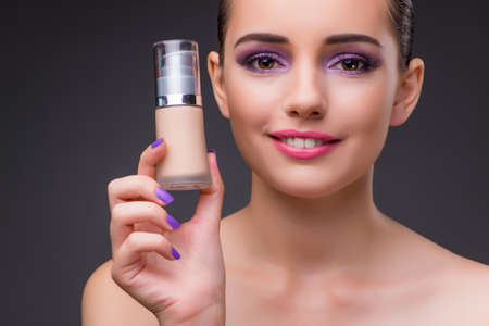 Woman with a bottle of creamの写真素材