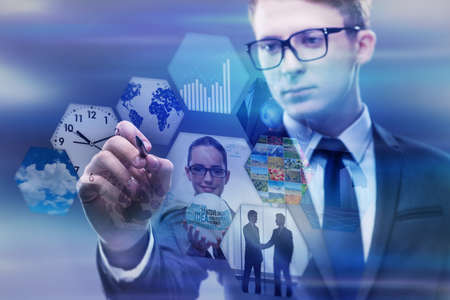 Businessman pressing virtual buttons in business conceptの写真素材