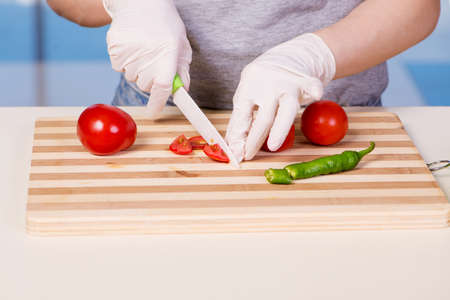 Hands of cook preparing saladの写真素材