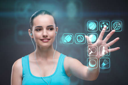 Young girl in sports concept pressing virtual buttonsの写真素材