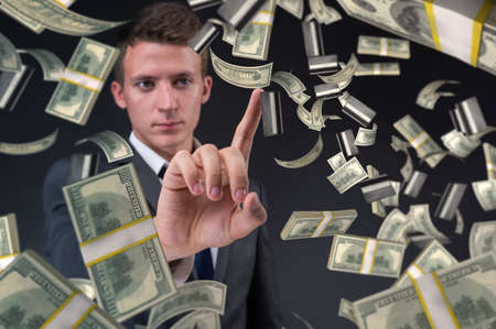 Man pressing virtual button with dollarsの写真素材