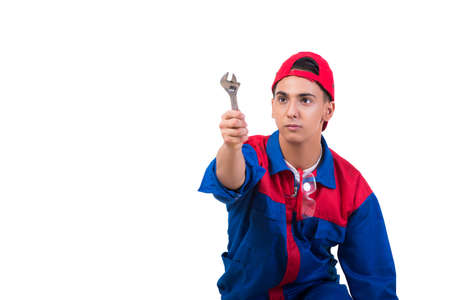Young repairman with wrench spanner isolated on whiteの写真素材