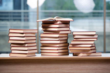 Stack of books arranged the office deskの写真素材