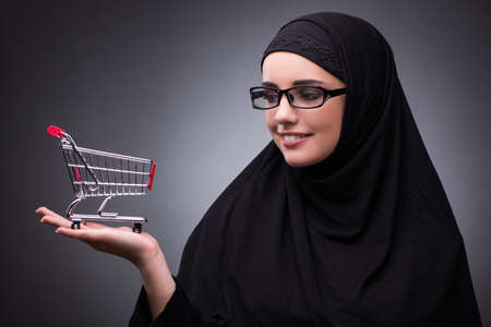 Muslim woman in black dress against dark backgroundの写真素材