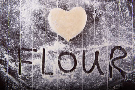 Cook preparing dough for baking in the kitchenの写真素材