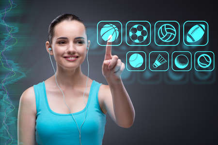 Young girl in sports concept pressing virtual buttonsの写真素材