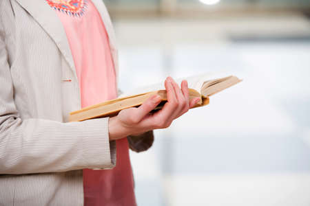 Young student reading book in preparation for examsの写真素材