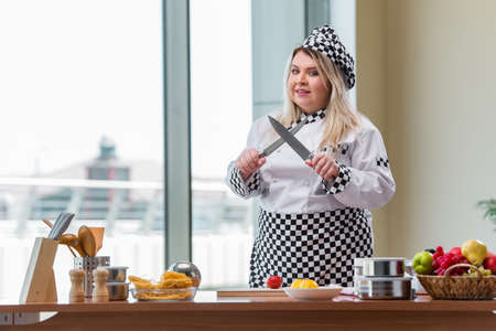 Young chef cook working in the kitchenの写真素材