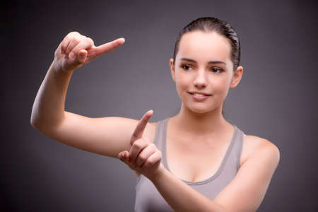 Woman in sports concept pressing buttonsの写真素材