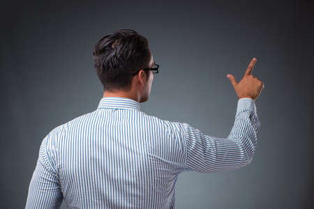 Handsome businessman pressing virtual buttons