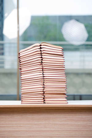 Stack of books arranged the office deskの写真素材