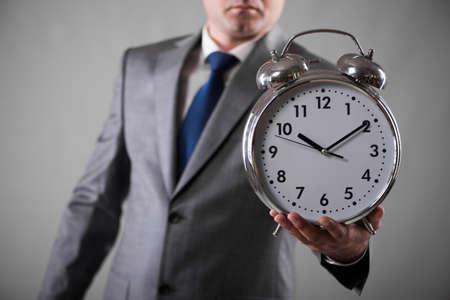 Businessman with clock in business concept