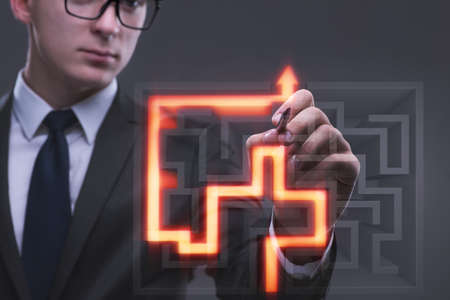 Businessman with maze in difficult situations conceptの写真素材