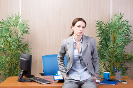 Woman under stress working in the officeの写真素材