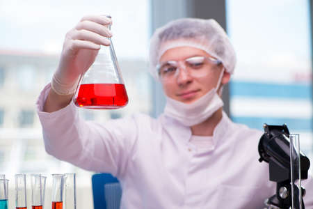 Man working in the chemical lab on science projectの写真素材