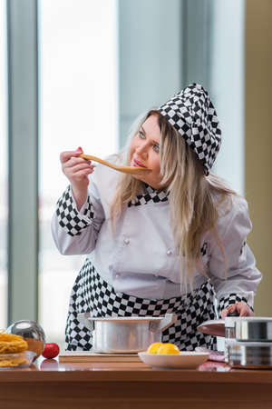 Female cook preparing soup in brightly lit kitchen