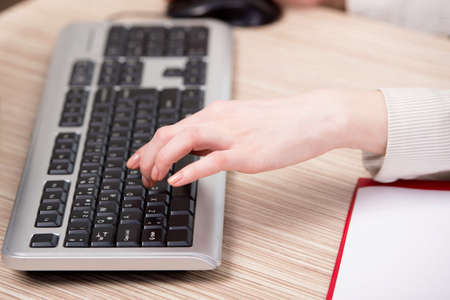 Hands working on the keyboard in the office