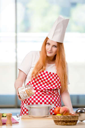 Redhead cook working in the kitchenの写真素材