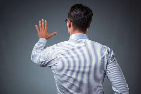 Handsome businessman pressing virtual buttonsの写真素材