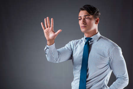 Handsome businessman pressing virtual buttonsの写真素材