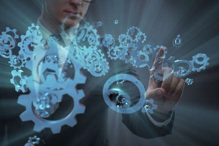Businessman with cogwheels gear in teamwork conceptの写真素材