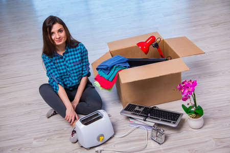 Young woman moving personal belongings