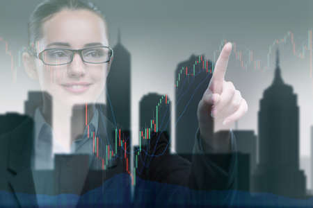 Businesswoman pressing buttons on line chartの写真素材